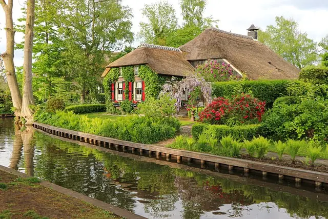 thatched roof – surrounded by a pretty garden
